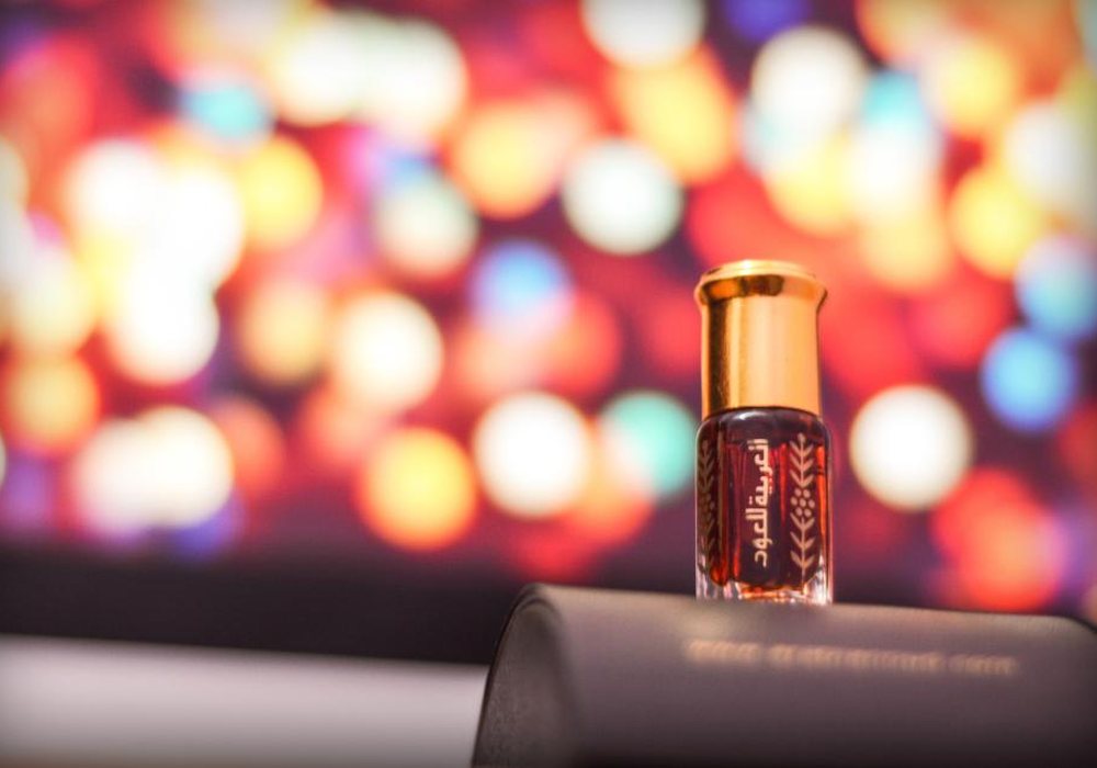A small glass bottle in front of colorful out-of-focus lights